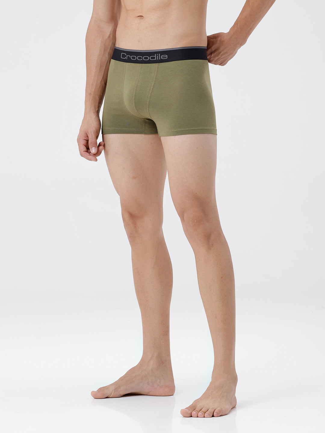 Person wearing green boxer briefs with a visible brand logo on a white background
