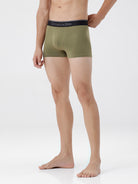 Person wearing green boxer briefs with a visible brand logo on a white background