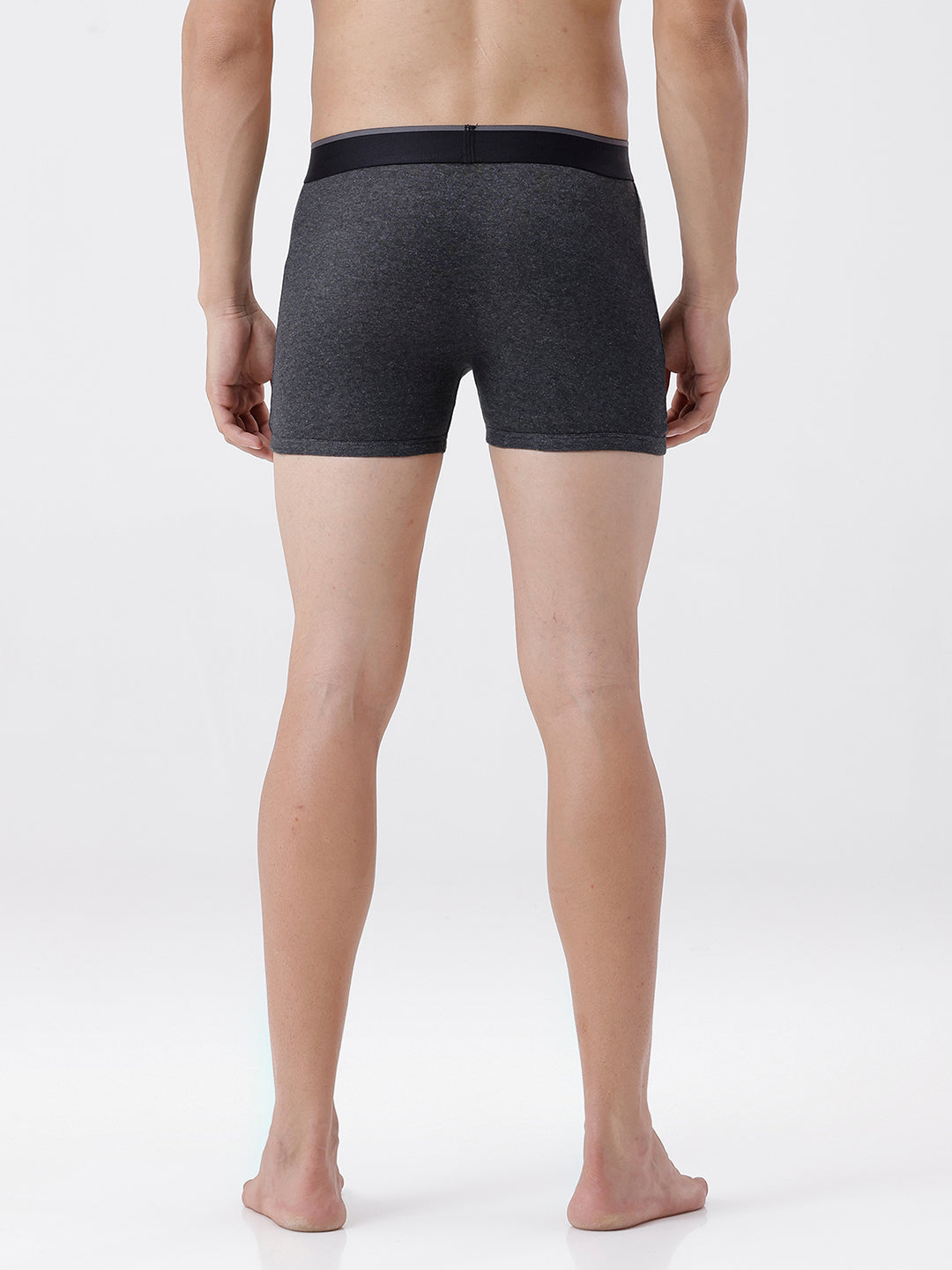 Person wearing dark gray boxer briefs on a white background