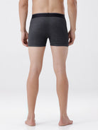 Person wearing dark gray boxer briefs on a white background