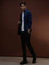 Man wearing a blue royal blue checked full sleeve 100% cotton shirt on a light gray background