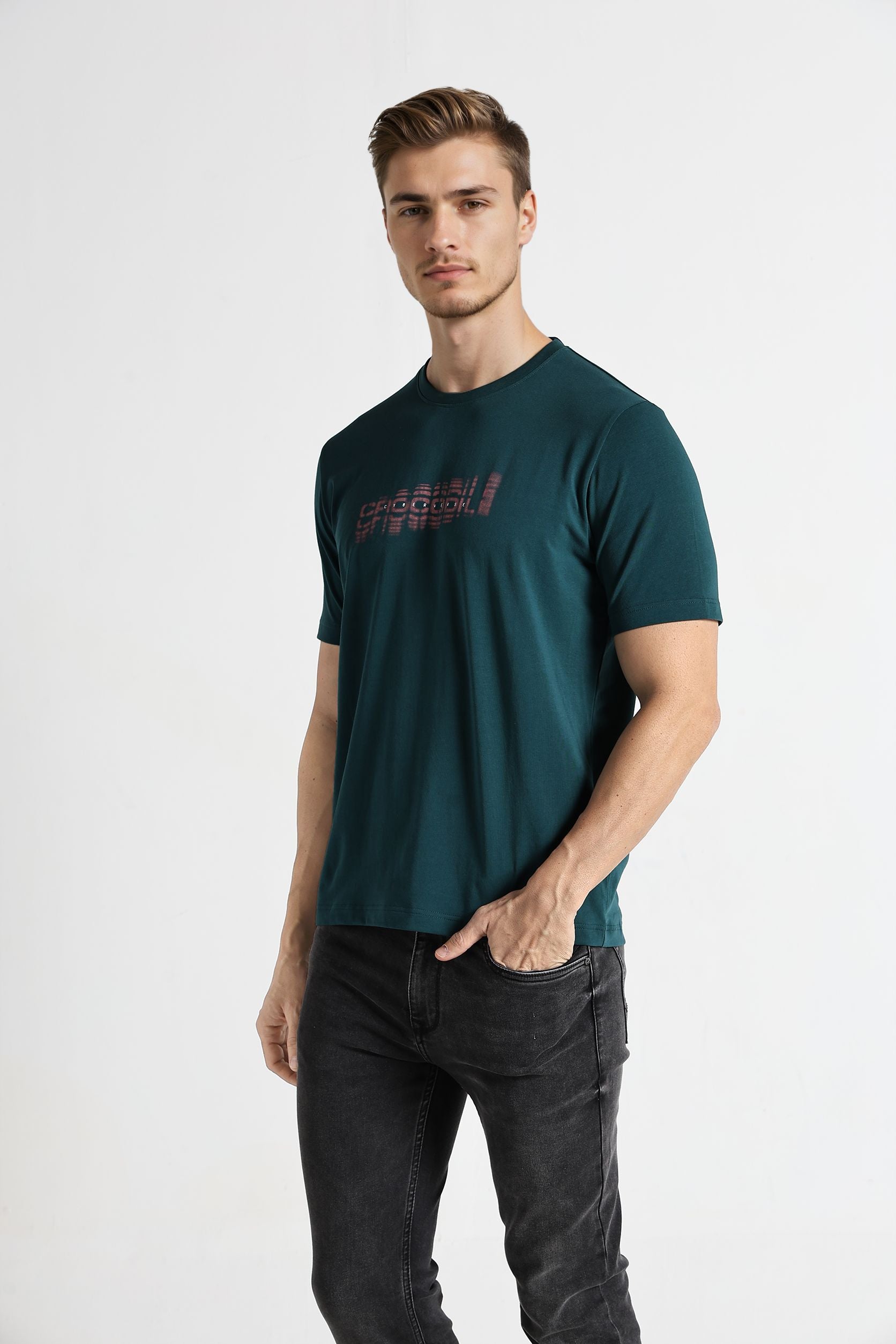 Man wearing a dark green t-shirt with text on a white background