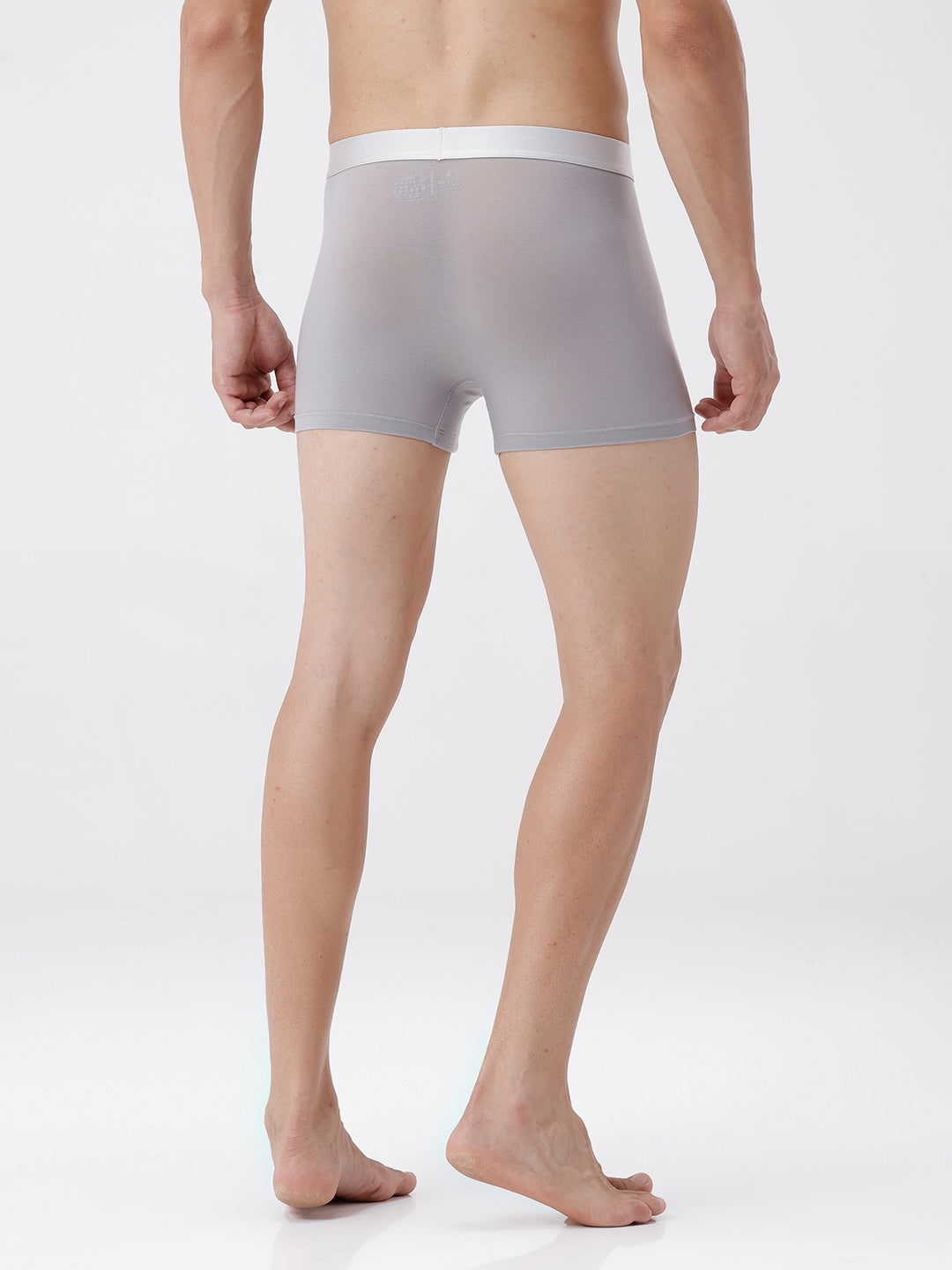Person wearing gray boxer briefs on a white background