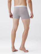 Person wearing gray boxer briefs on a white background