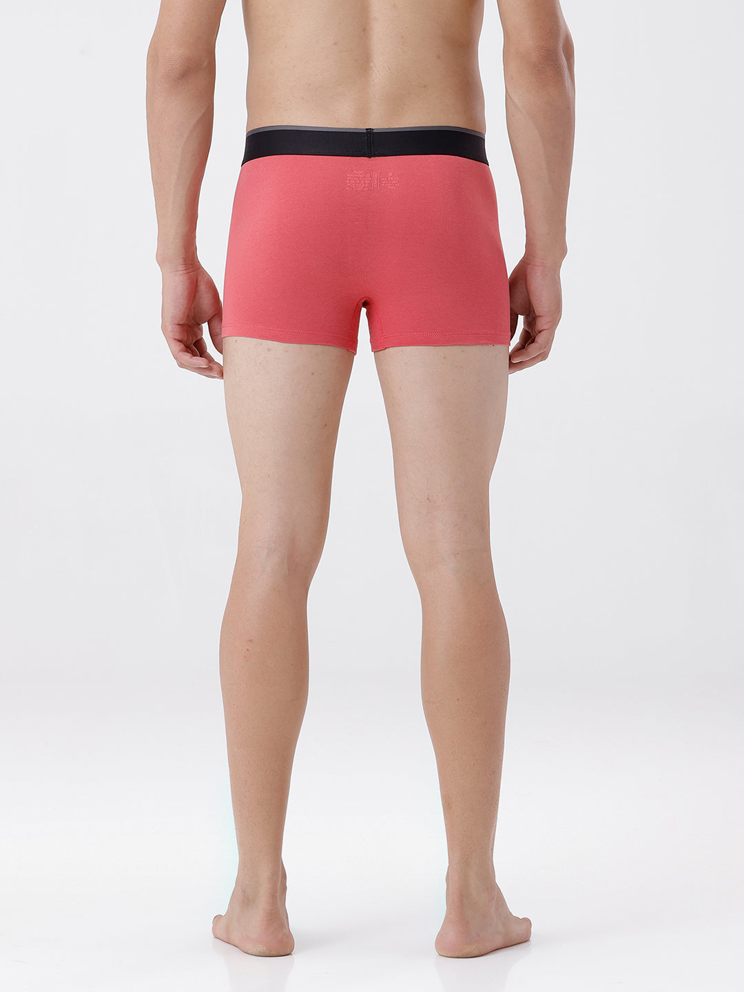 Person wearing red boxer briefs on a white background