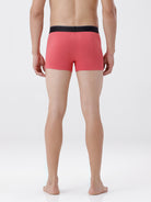 Person wearing red boxer briefs on a white background