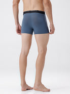 Person wearing a pair of blue boxer briefs on a white background