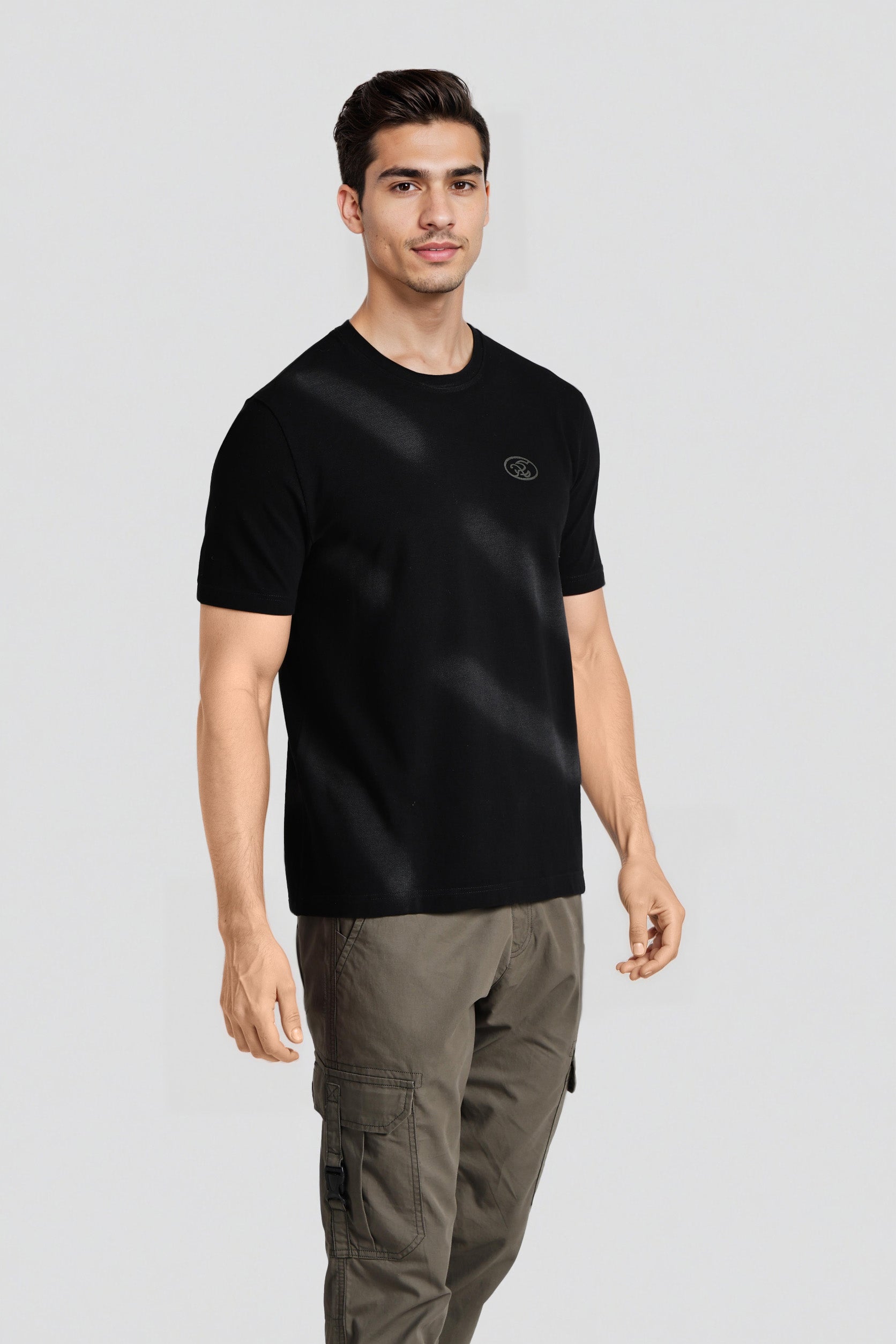 Man wearing a black t-shirt with a logo on a gray background