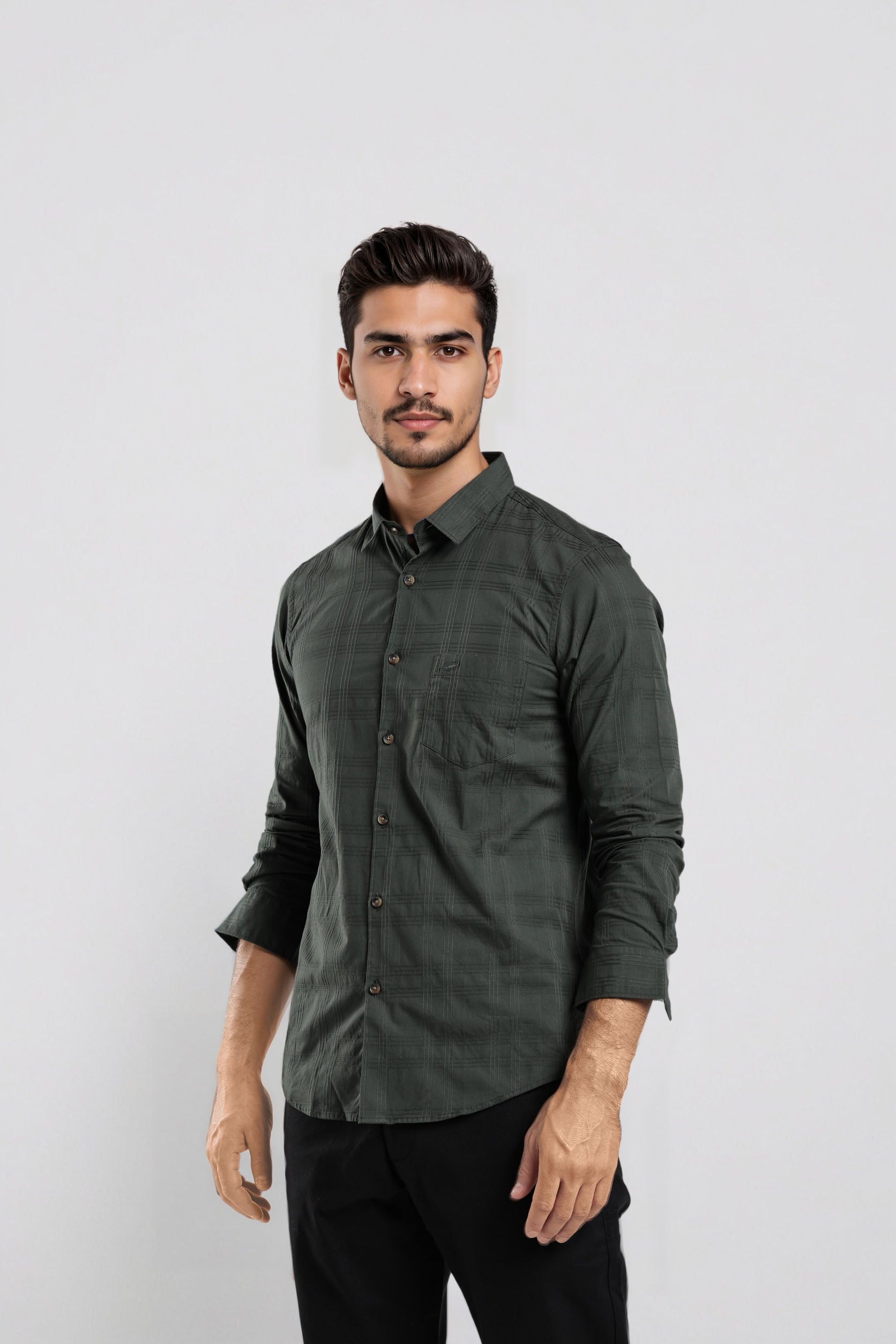 Man wearing a dark green button-up shirt against a white background