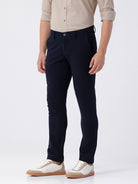 Man wearing a red textured essential chinos navy with casual styling on a gray background