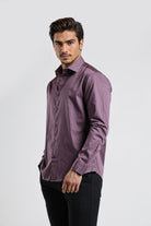 Man wearing a purple shirt against a white background