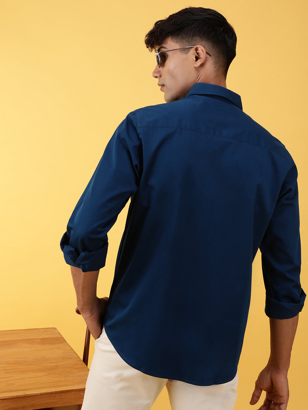 Man wearing a blue royal blue solid full sleeve 100% cotton casual shirt with casual styling on a gray background