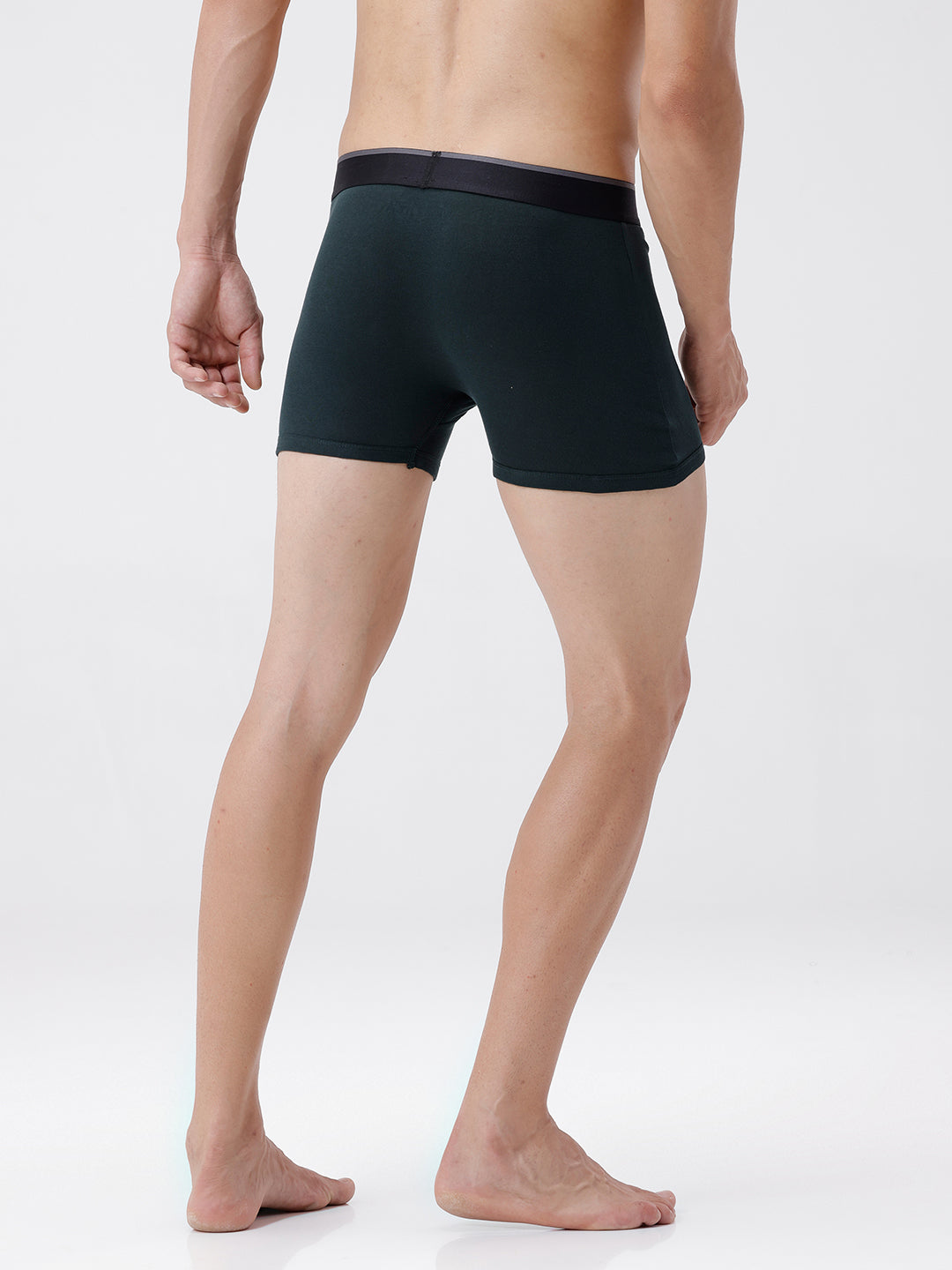 Person wearing black boxer briefs on a white background