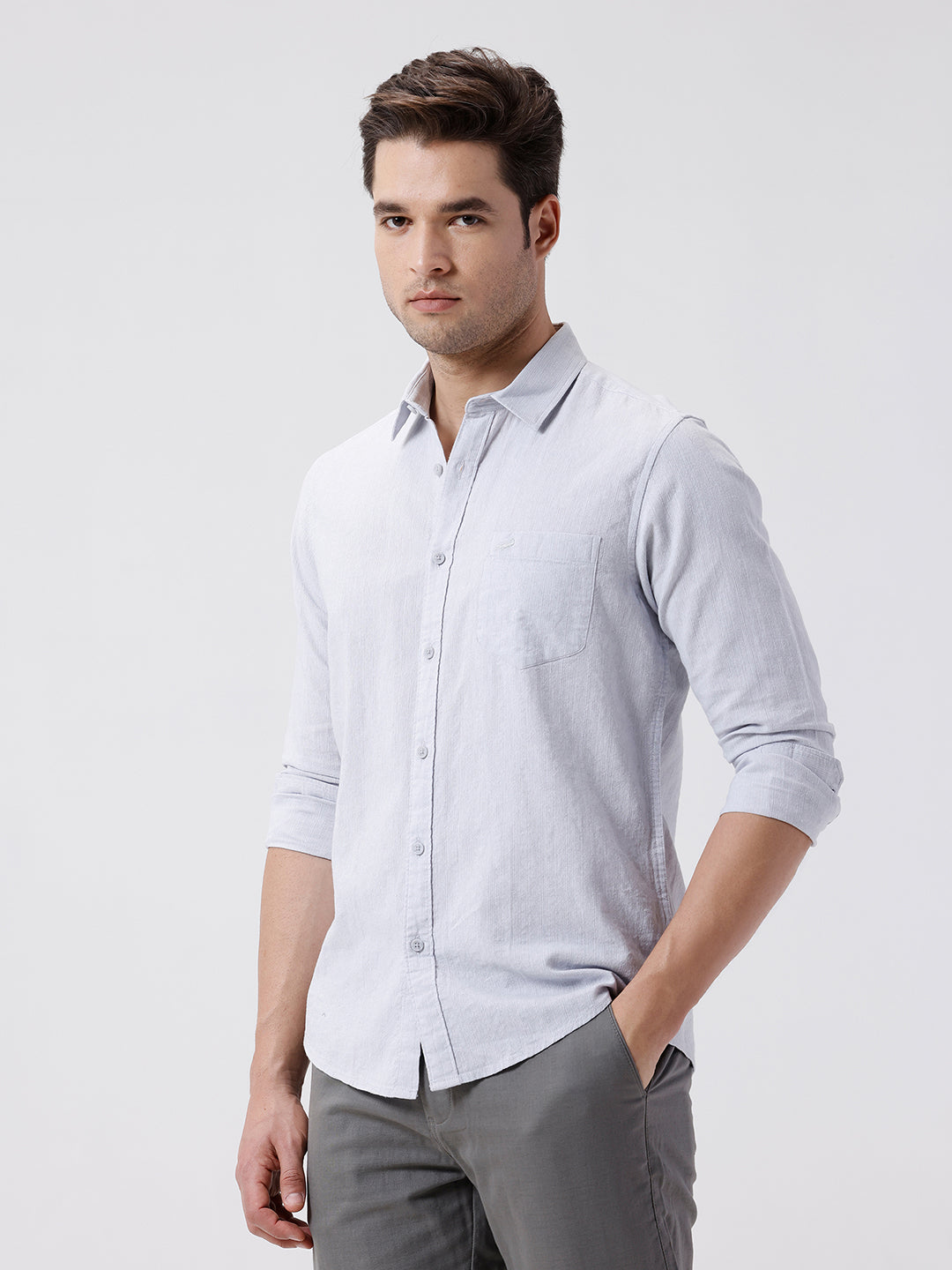 Man wearing a grey rib textured cotton shirt grey on a light gray background