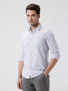 Man wearing a grey rib textured cotton shirt grey on a light gray background