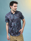 Man wearing a navy casual navy printed half sleeve 100% cotton shirt with casual styling on a gray background