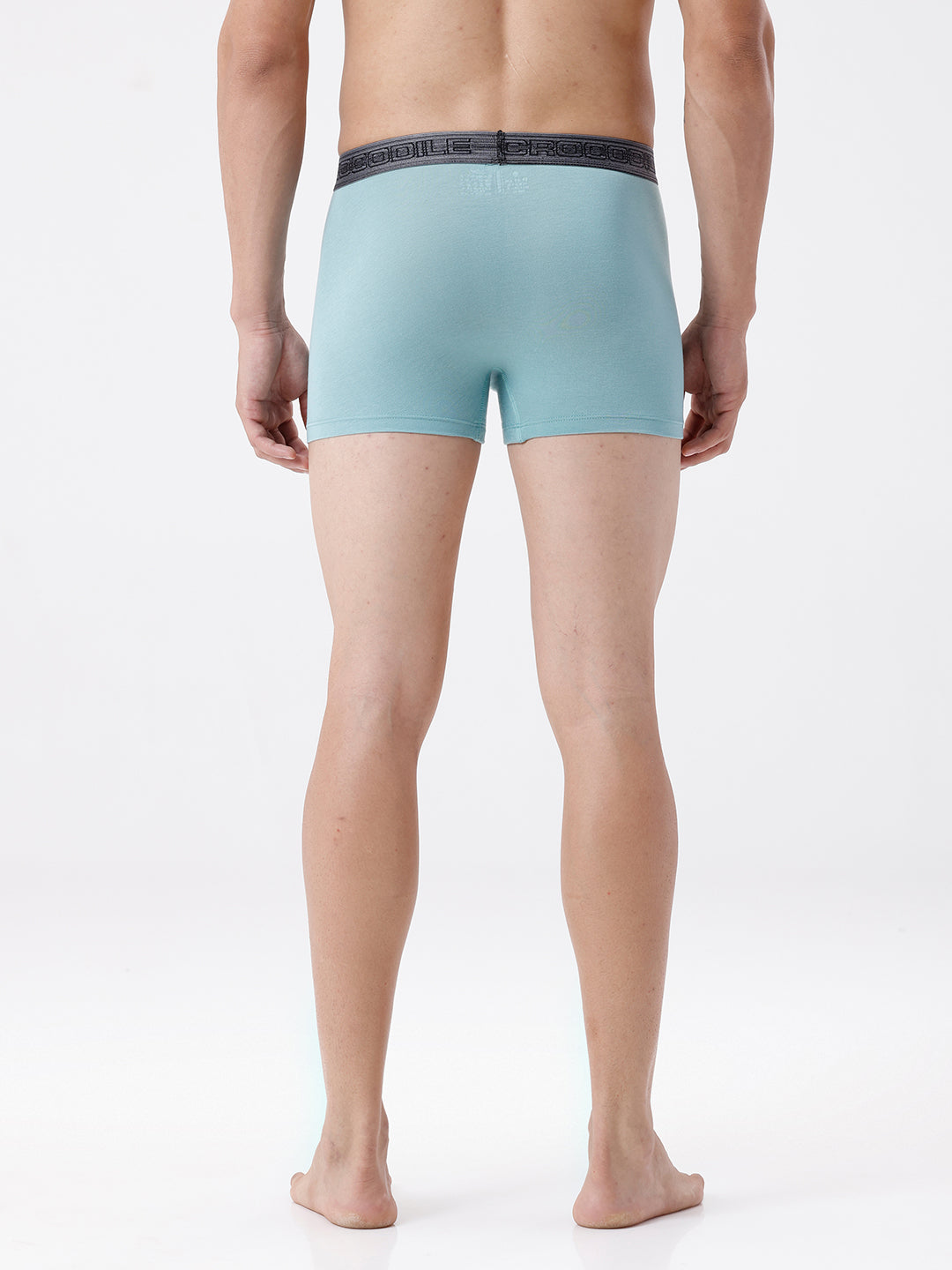 Person wearing light blue boxer briefs on a white background