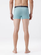 Person wearing light blue boxer briefs on a white background