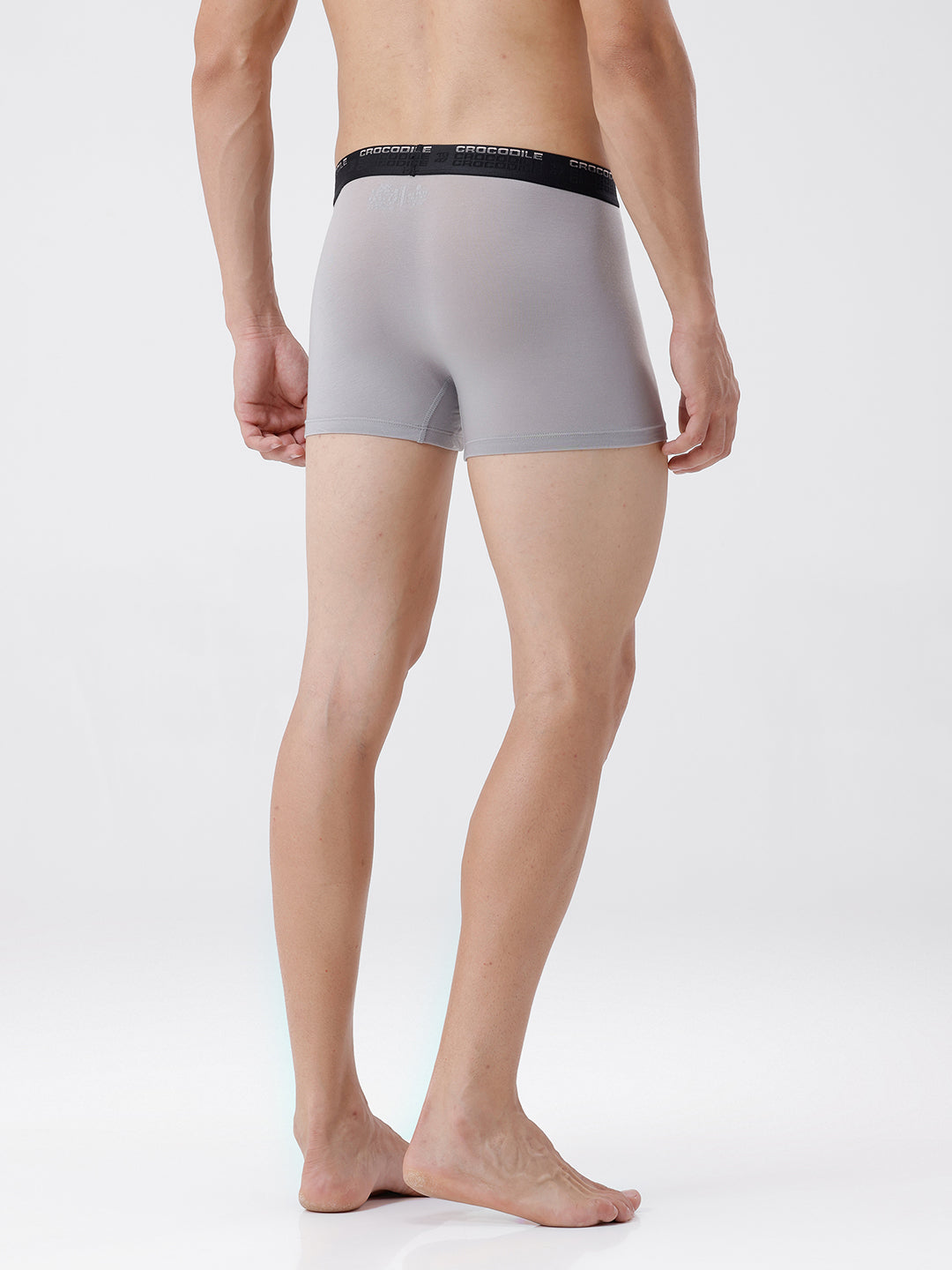 Person wearing gray boxer briefs with black waistband on a white background