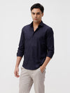 Man wearing a navy mercerized stretch shirt navy with casual styling on a gray background