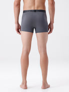 Person wearing gray boxer briefs on a white background