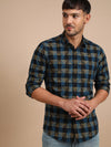 Man wearing a brown checked brown full sleeve casual 100% cotton shirt on a light gray background