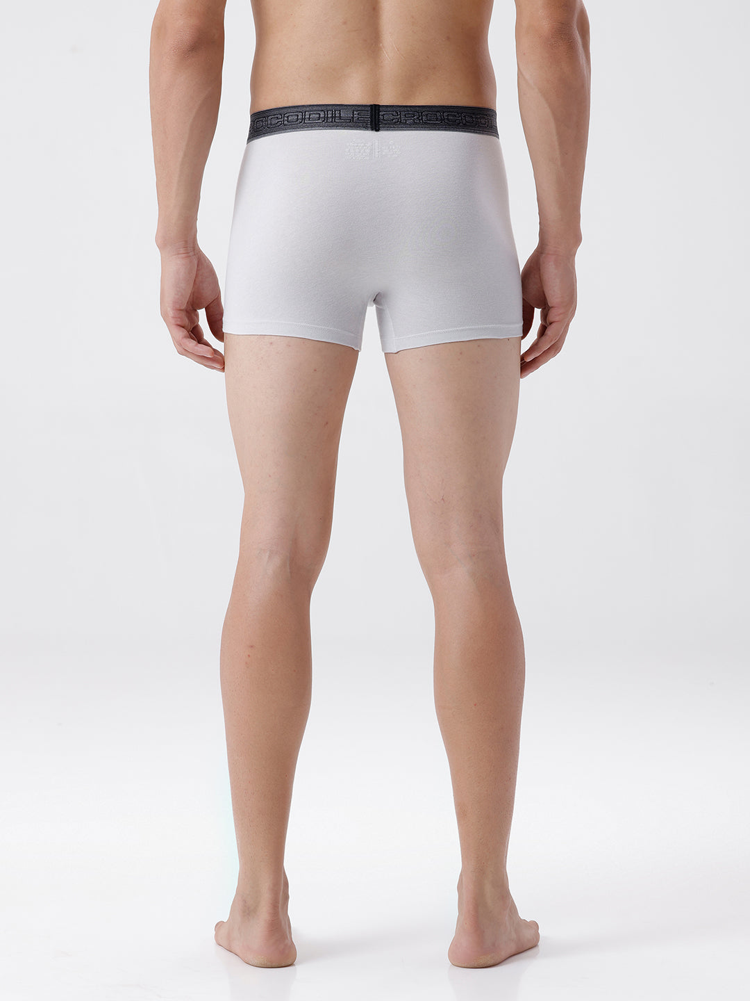 Person wearing white boxer briefs with a black waistband on a white background
