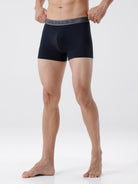 Person wearing black boxer briefs on a white background