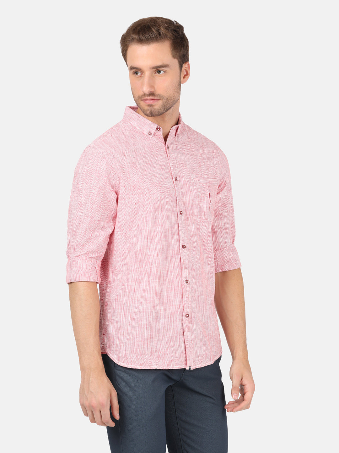 Man wearing a red red striped casual full sleeve 100% cotton shirt on a light gray background