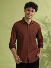Man wearing a brown brown printed full sleeve 100% cotton shirt on a light gray background