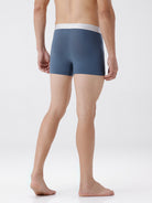 Person wearing a pair of blue boxer briefs on a white background