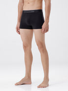 Person wearing black boxer briefs with 'Crocodile' branding on a white background