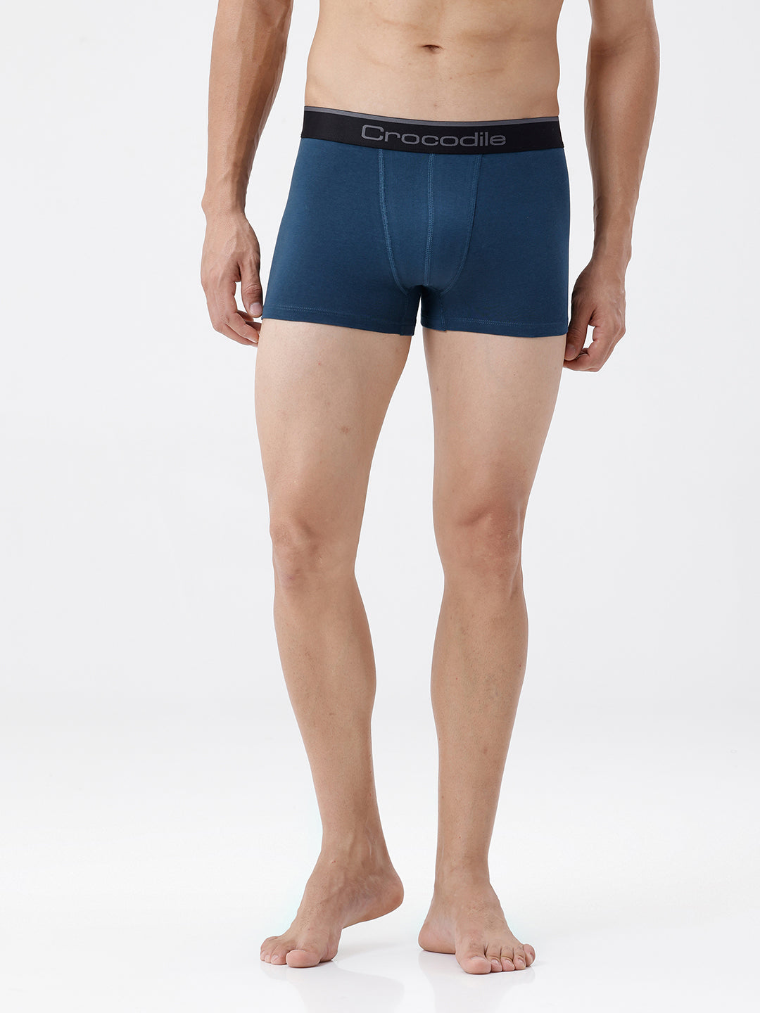 Man wearing blue boxer briefs with 'Crocodile' branding on a white background