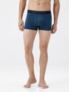 Man wearing blue boxer briefs with 'Crocodile' branding on a white background