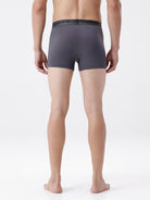 Person wearing gray boxer briefs on a white background