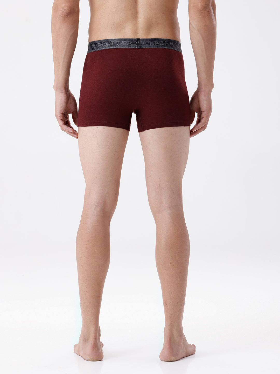 Maroon boxer briefs worn by a person on a white background