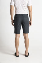 Person wearing gray shorts and a white shirt on a white background