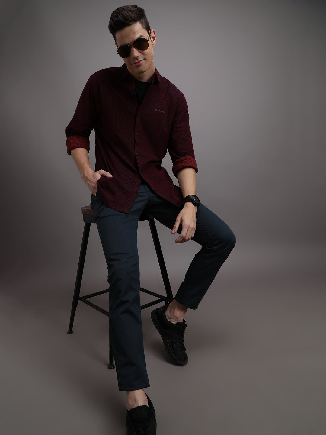 Man wearing a red red striped full sleeve 100% cotton shirt on a light gray background