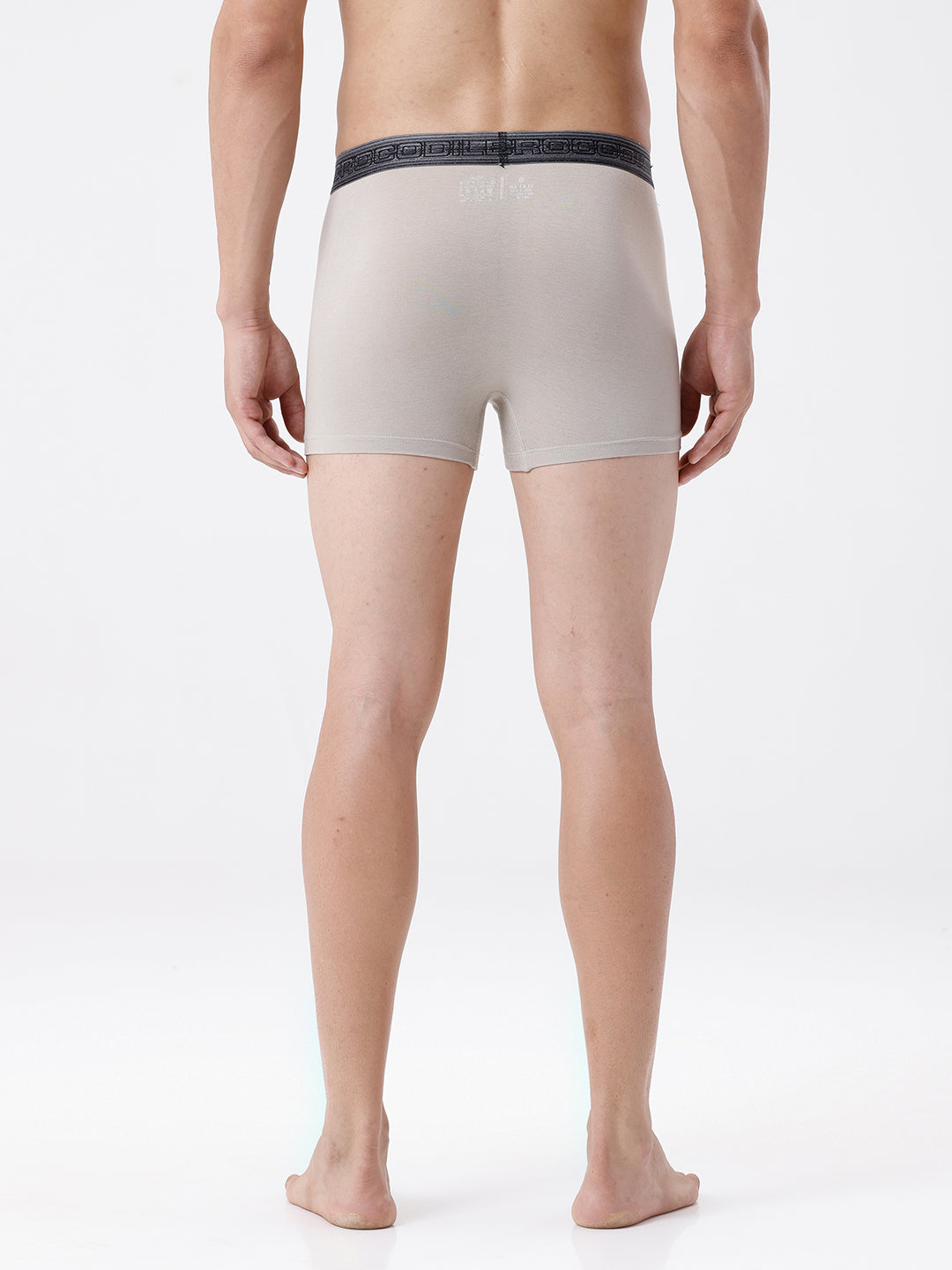 Person wearing beige boxer briefs on a white background
