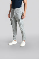 Person wearing gray cargo pants on a light gray background