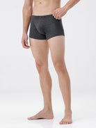 Person wearing gray boxer briefs on a white background