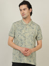 Man wearing a beige beige printed casual polo t shirt with casual styling on a gray background