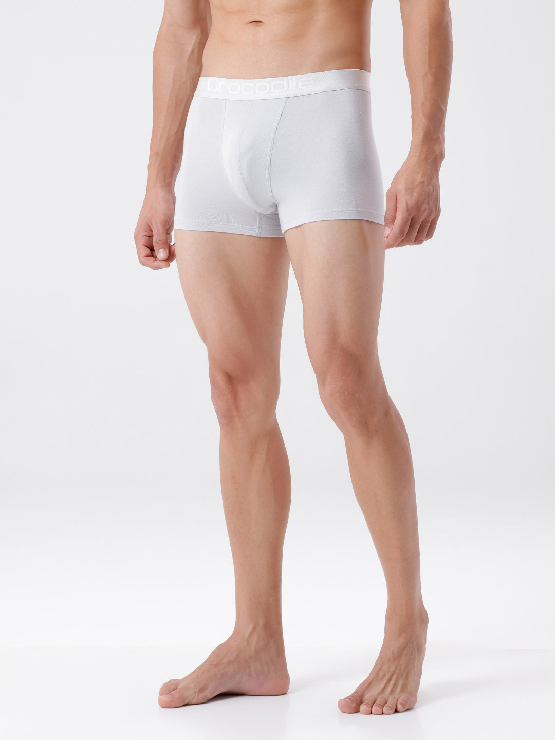 Man wearing white boxer briefs on a plain background