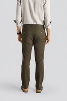 Person wearing olive green pants on a plain background