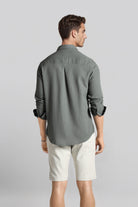 Man wearing a gray shirt and white shorts on a light gray background