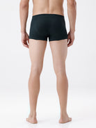 Person wearing black boxer briefs on a white background