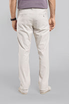 Person wearing light-colored pants on a gray background