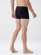 Person wearing black boxer briefs on a white background