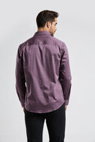 Man wearing a purple shirt from behind on a white background