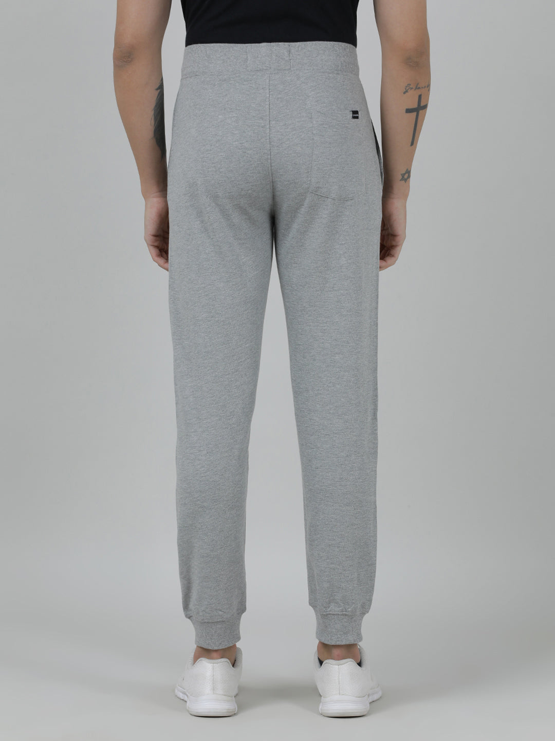 Person wearing gray sweatpants on a plain background